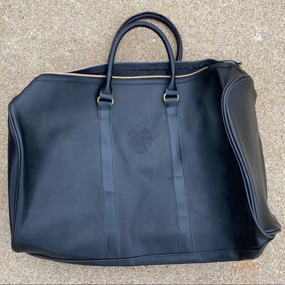 new black overnight bag, labeled Trump